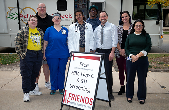 Students and faculty volunteer giving HIV, Hep C, and STI screenings to the Peoria community
