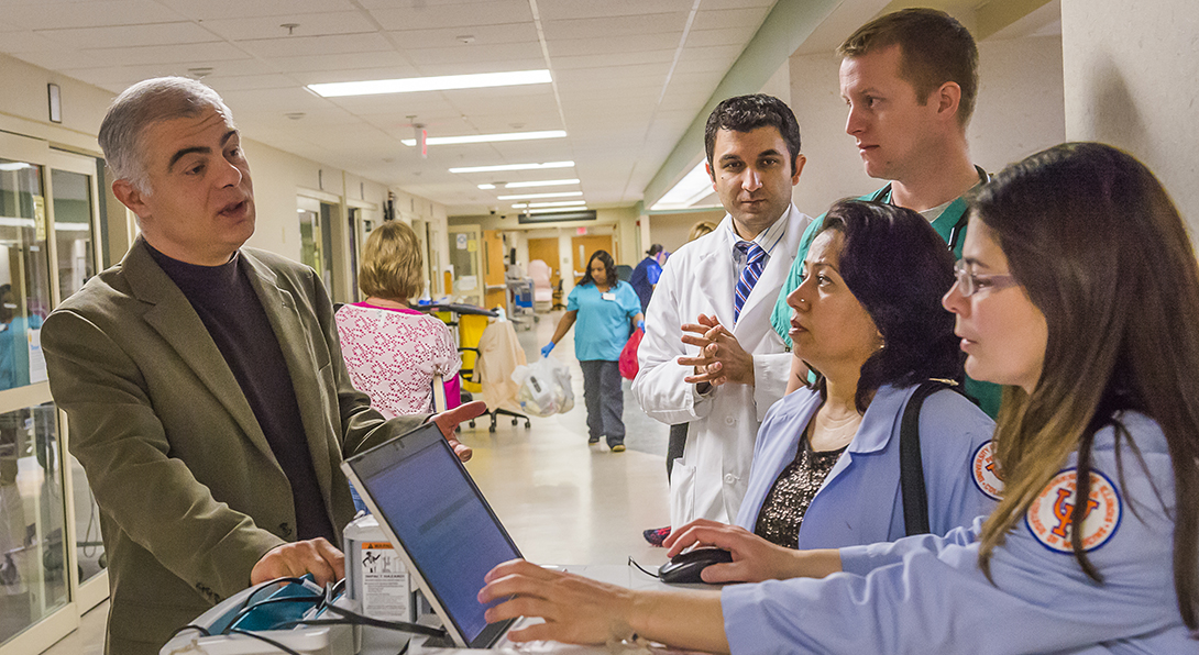 Neurology faculty member speaks with residents at OSF Saint Francis