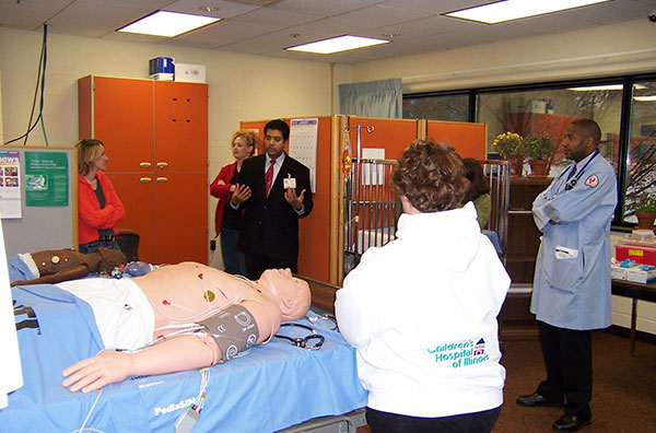 Healthcare Professionals and Students Studying a Computerized Mannequin