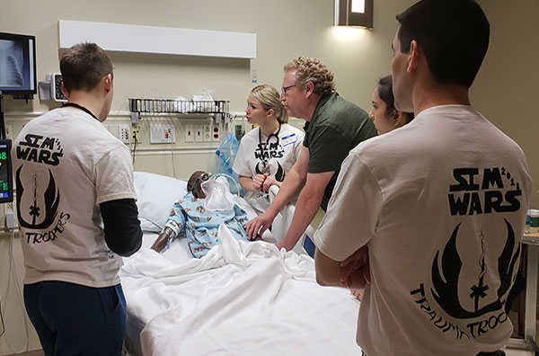 Medical Students Next to a Mannequin During the first annual Sim Wars