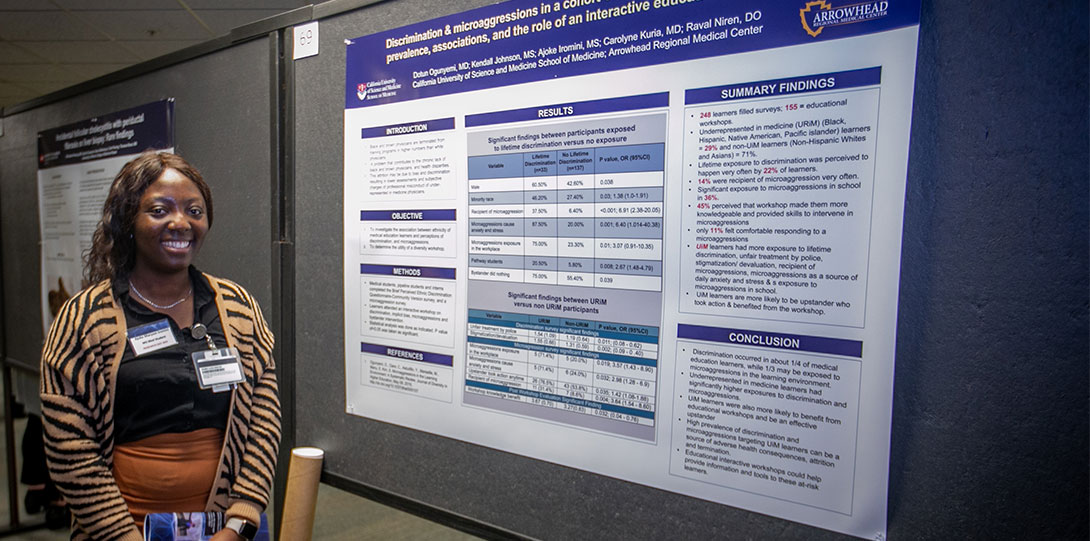 A Medical Student Standing in Front of Her Presentation During Research Day