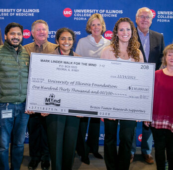 Mark Linder Walk for the Mind representatives present a check to support brain tumor research at UICOMP.
                  