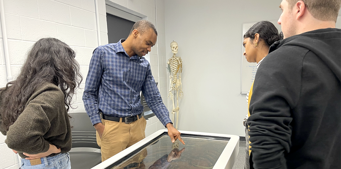 Professor demonstrates Anatomage table to medical students