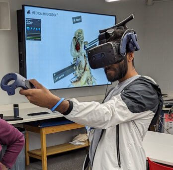 Medical Student doing virtual reality heart exercise 