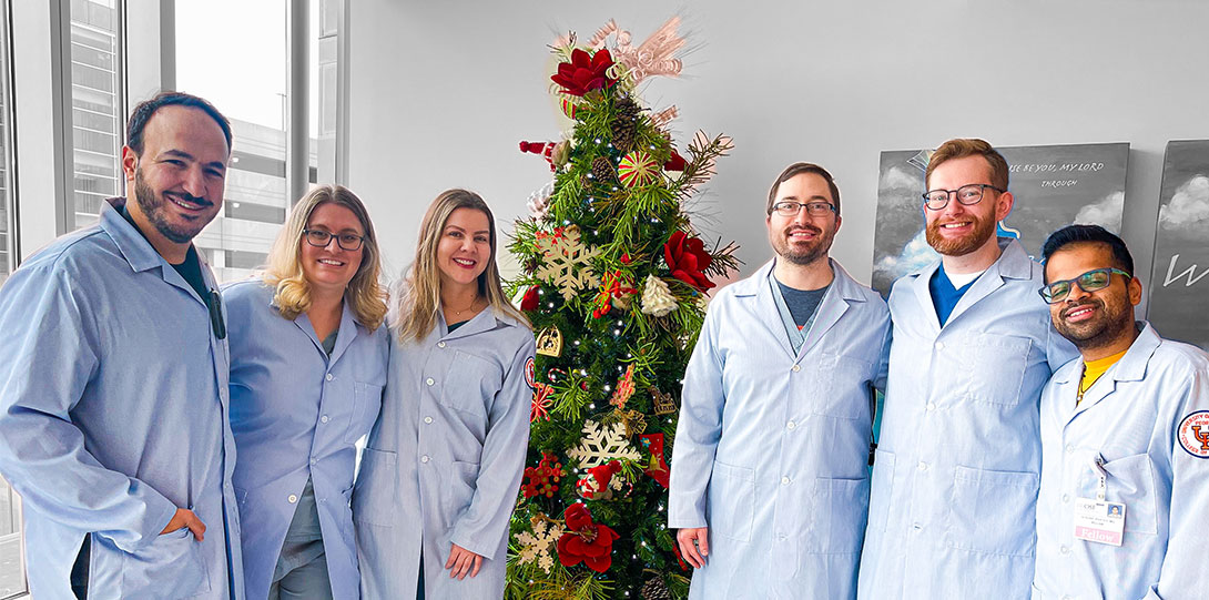 Neonatal-Perinatal group photo in front of Christmas tree