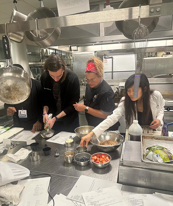 Family Medicine residents prepare healthy recipes in a teaching kitchen