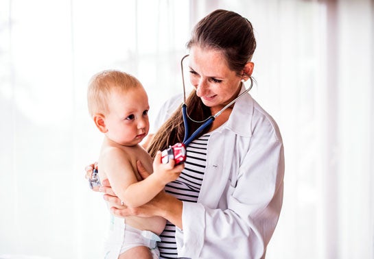 baby being held by a doctor