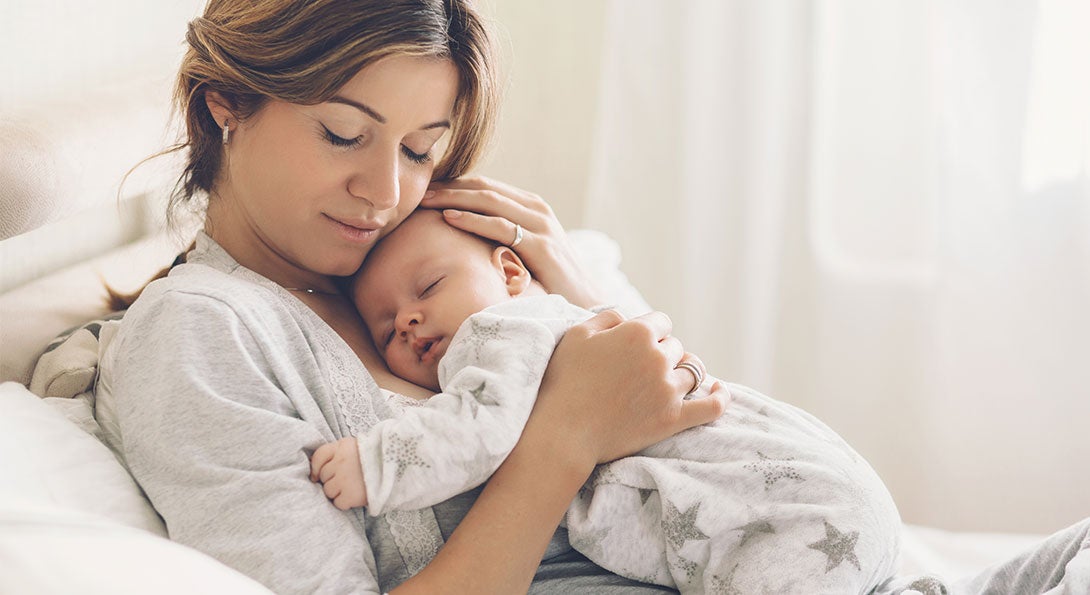 main image - newborn baby with mother