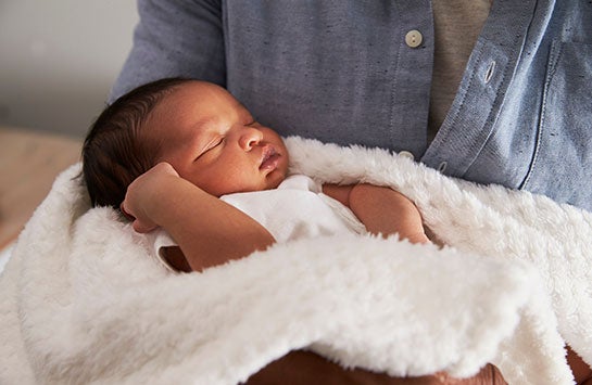 baby being held by its mother