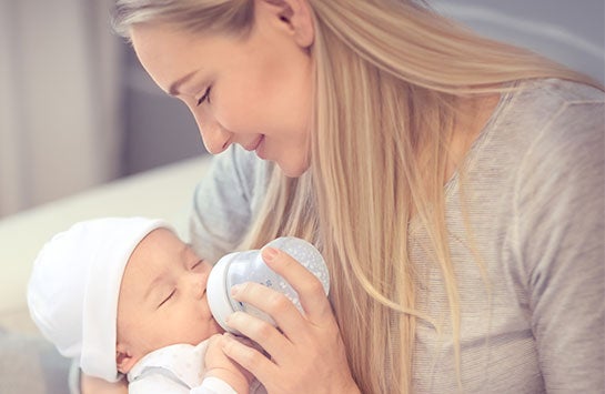 Newborn being fed by its mother