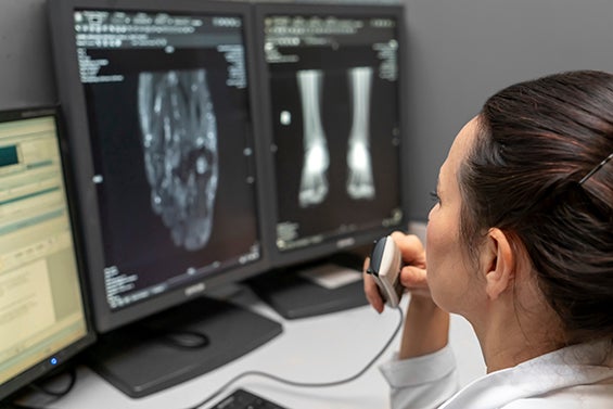 A radiologist reads and X-ray and dictates