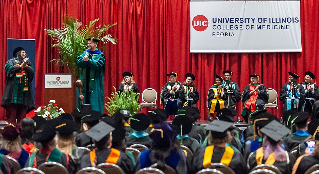 students at convocation sitting in chairs