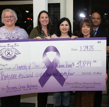 The Theresa Tracy Trot organization presents a check for $39,844 to the University of Illinois College of Medicine Peoria to support pancreatic cancer research
                  