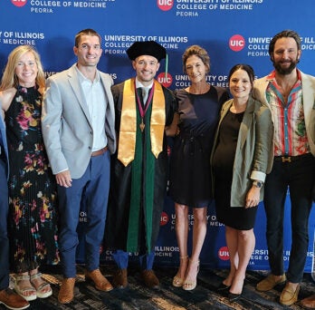 Marcus Rossi and his family pose at UICOMP Convocation
                  