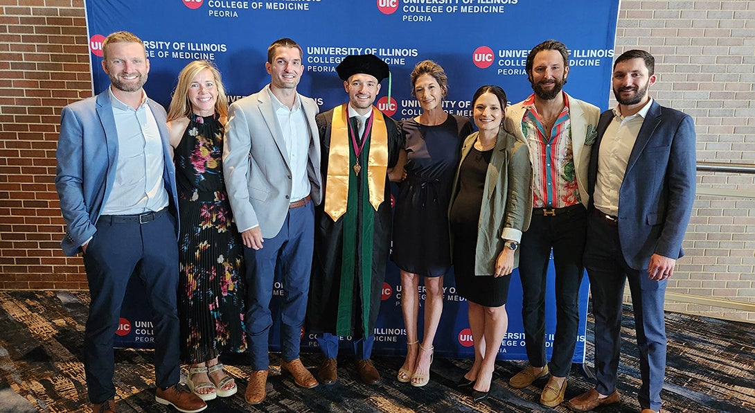Marcus Rossi and his family pose at UICOMP Convocation